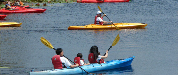 Kids Kayaking on the Lake Lafayette. They are wearing life vest and look very safe.